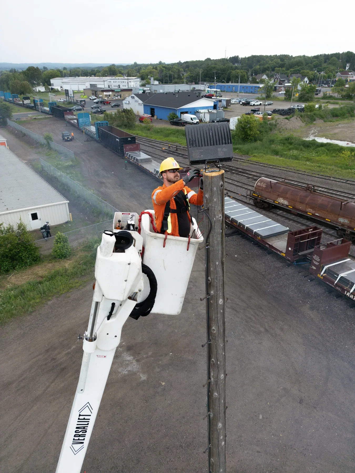 Veteran Electric utility crew member working on a pole from an elevated bucket